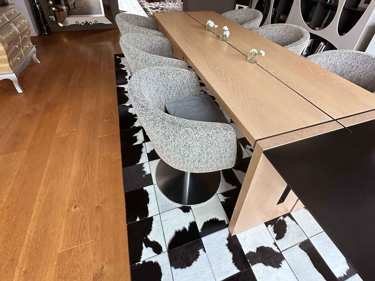 Custom Black & White Cowhide Patchwork Rug in Dining Room, Zoomed View