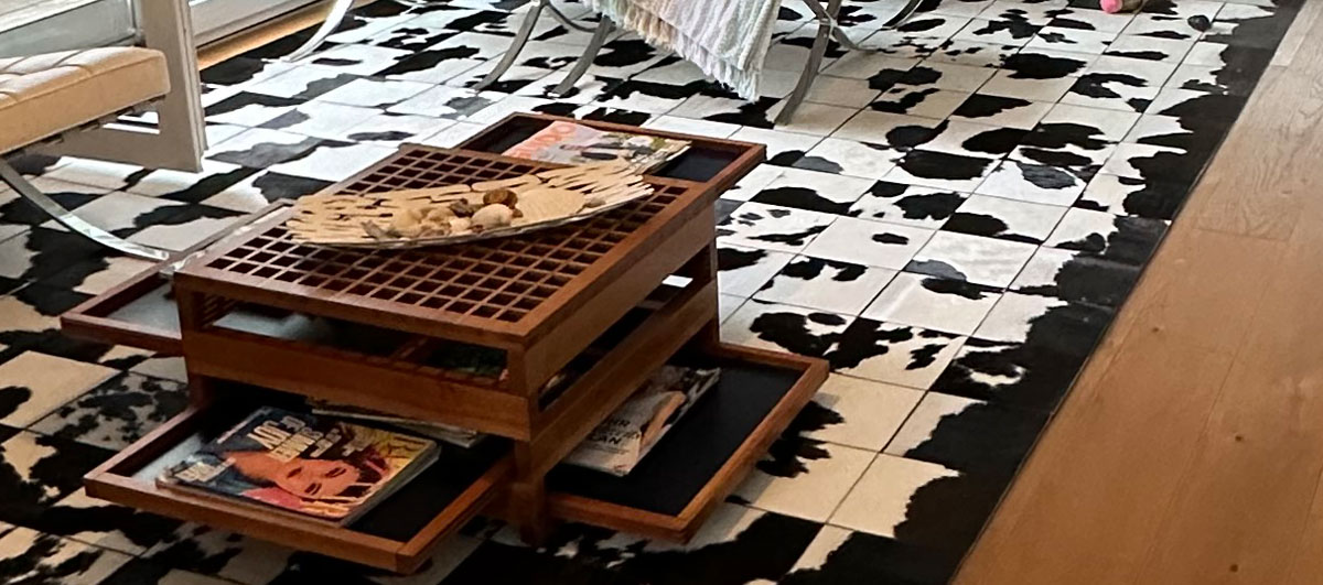 Detail of the edges of the custom-made Black & White cowhide patchwork rug in the living room