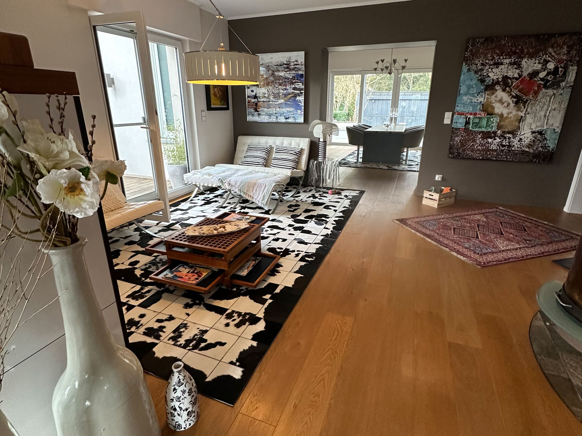 Custom made Black & White cowhide patchwork rug in living room, zoomed view